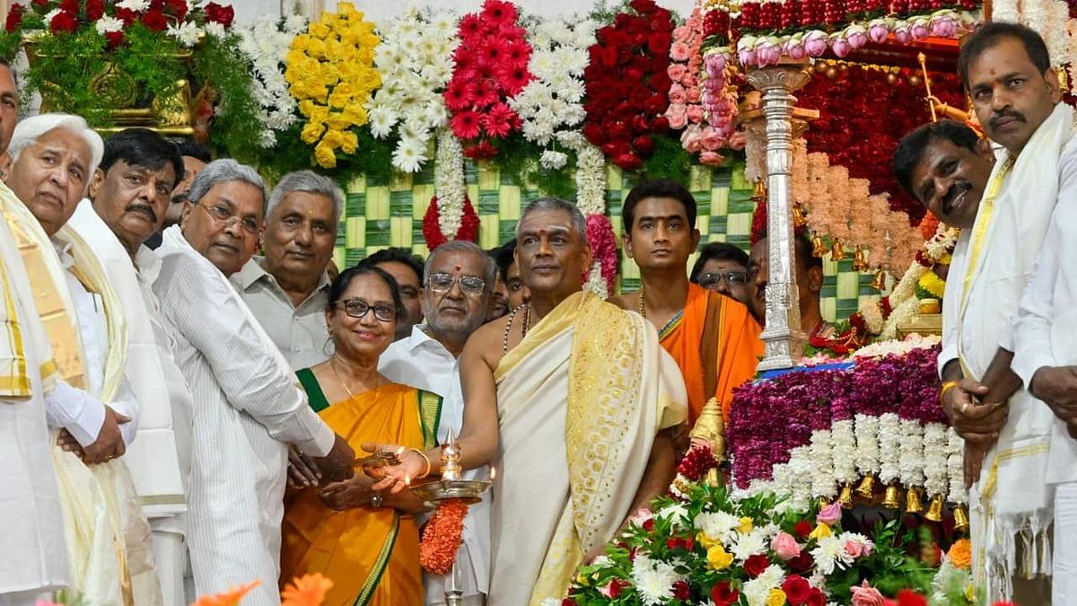 Banu Mushtaq helps light the sacred lamp before showering flowers on Devi Chamundeshwari