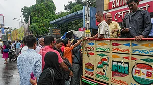 Cloudburst cripples Kolkata; residents ride pickup trucks through flooded streets