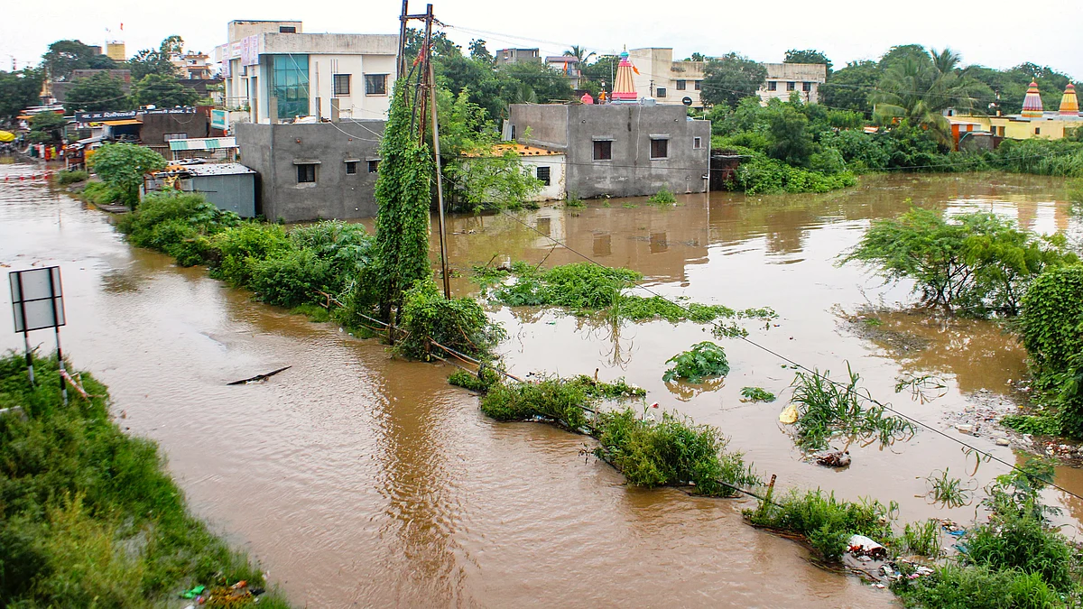 Water from the Sina river floods roads and homes after heavy rains, in Solapur, 23 Sept