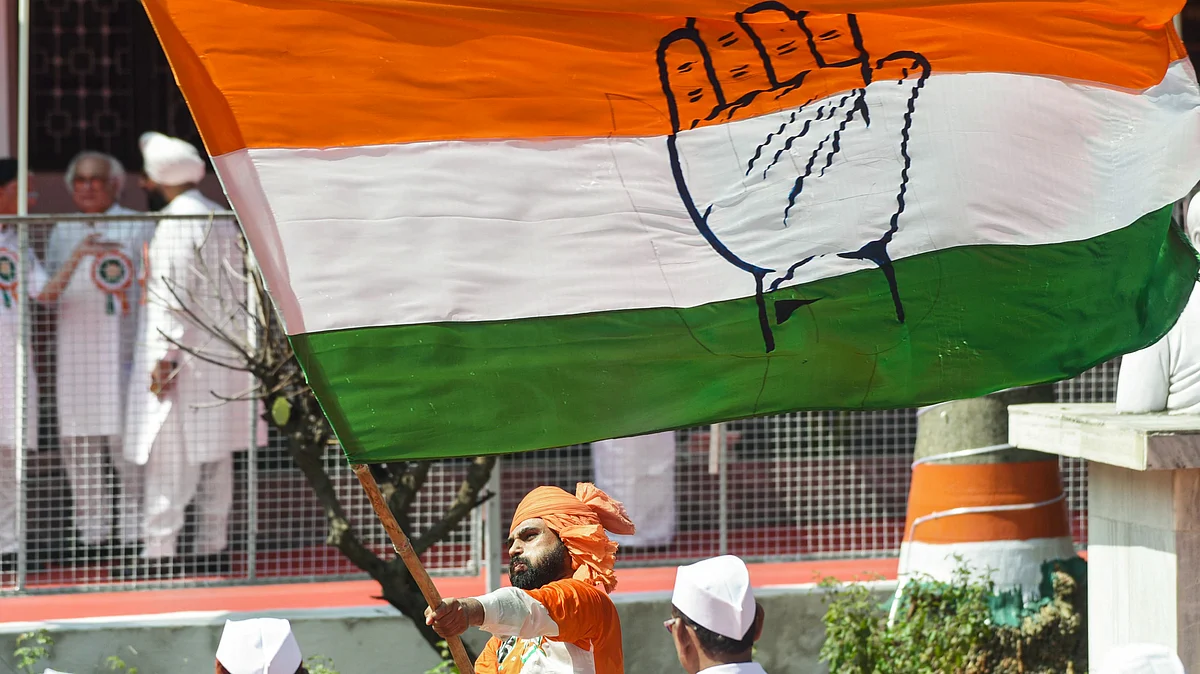 A supporter holds an INC flag at the CWC meeting at Sadaqat Ashram, Patna 24 Sept