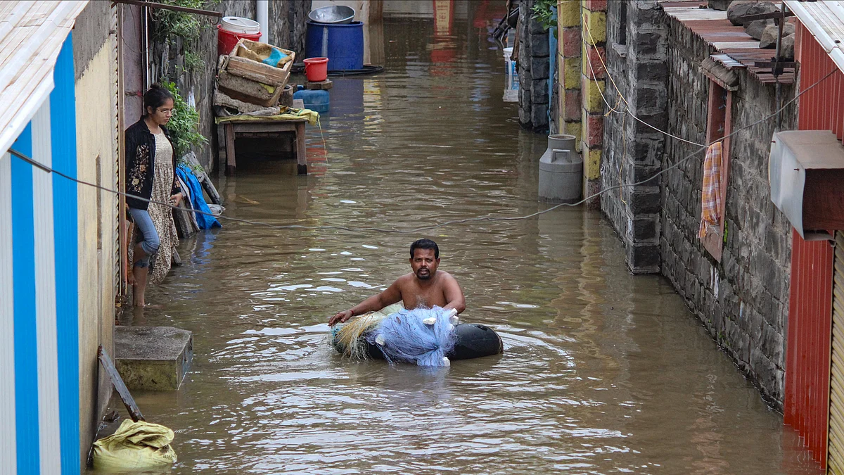 A person makes his way through a flooded area in Solapur district