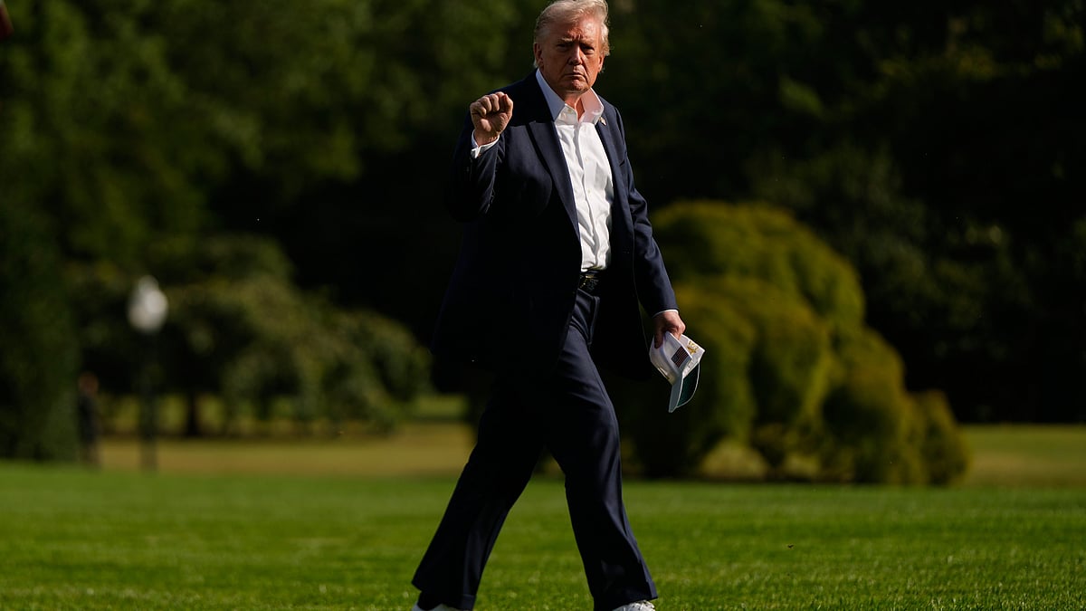 Donald Trump gestures as he arrives at the White House.