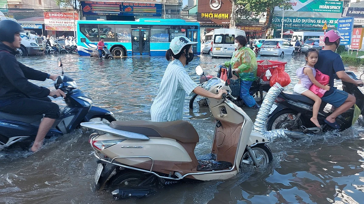 Commuters struggle through floodwaters in Vietnam.