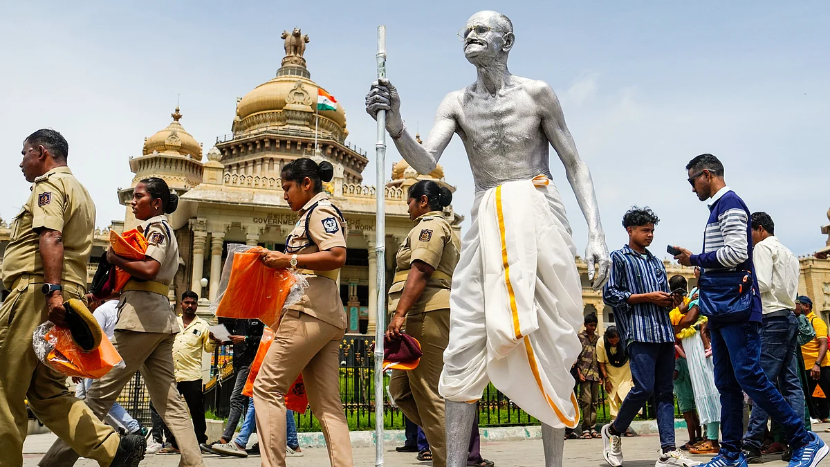 Shankarappa (62) dressed as Mahatma Gandhi, in front of Vidhanasoudha in Bengaluru