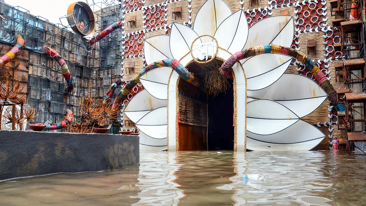 Rainwater floods a Durga Puja pandal in Kolkata, dampening festivities.