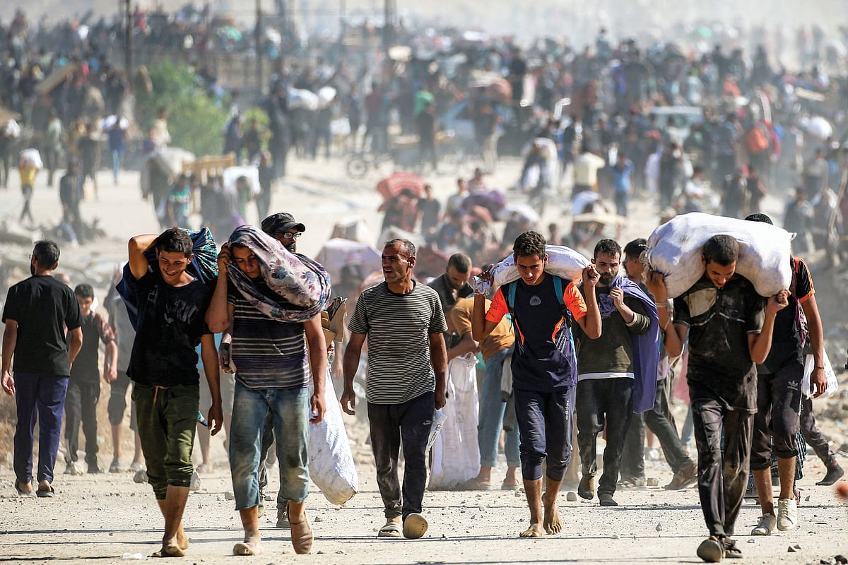 Displaced and starving Gazans carrying food from an aid centre