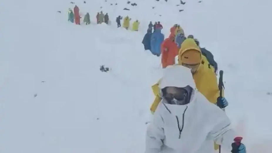 escue teams work to evacuate climbers stranded by a blizzard on Everest.