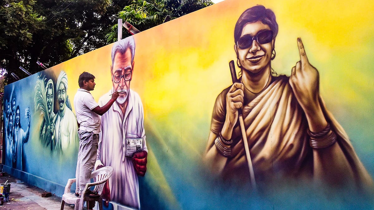 An artist paints a mural ahead of the Bihar Assembly elections, in Patna, 7 Oct