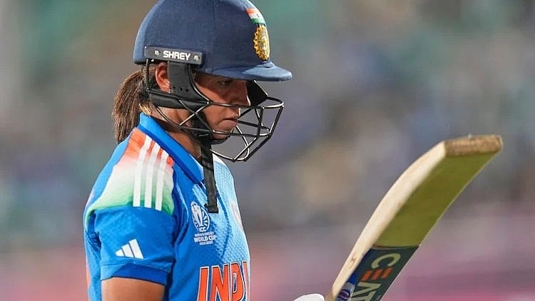 A distraught Harmanpreet Kaur walks back after being dismissed against South Africa