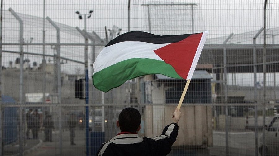 A child waves a Palestinian flag near the border