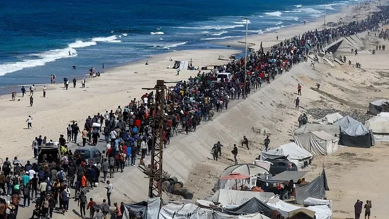Palestinians walking on the coastal road