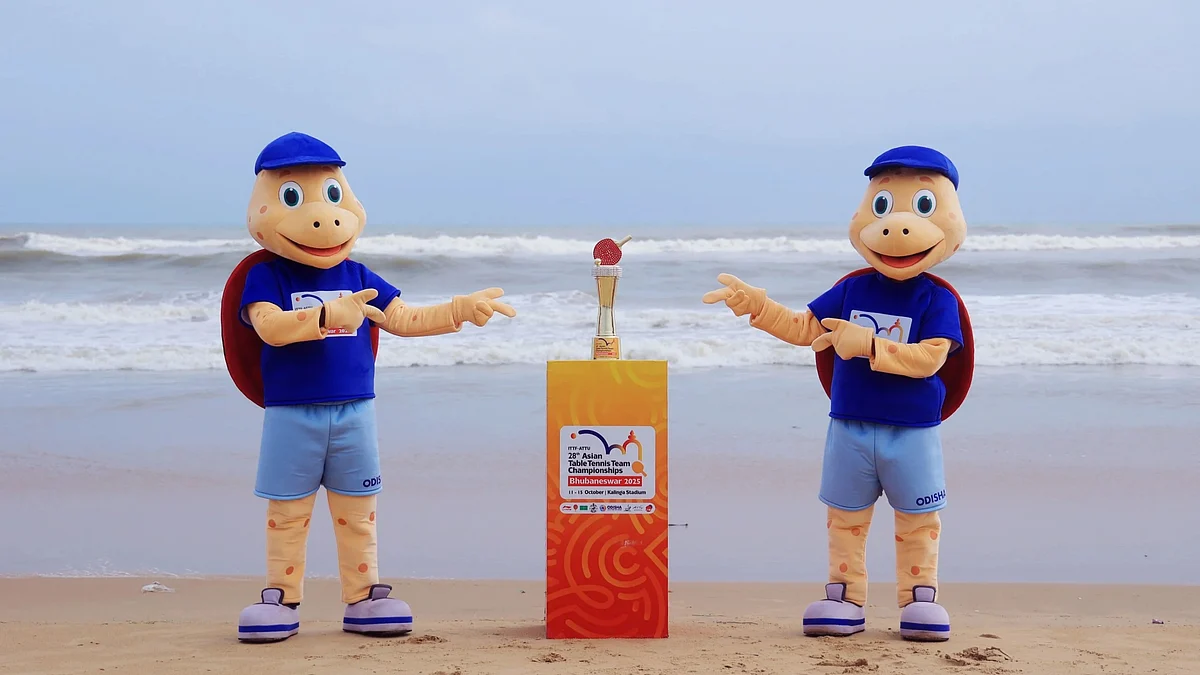 Olly, mascot of Asian table tennis, strike a pose with winners' trophy in Puri