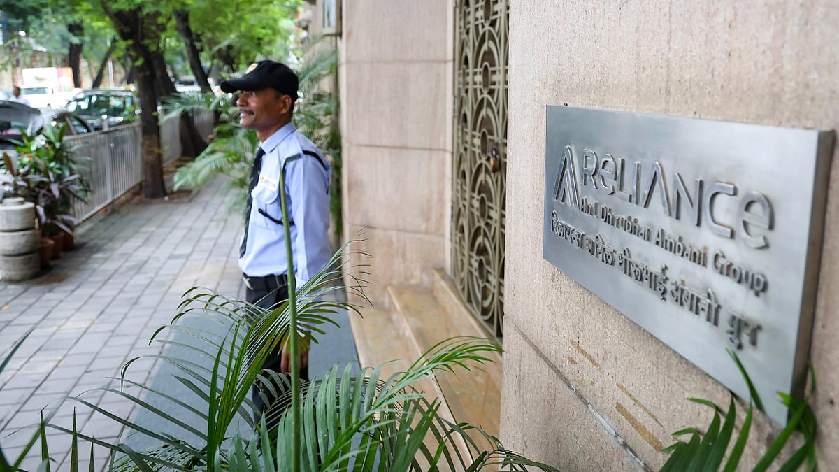 A security guard stands outside industrialist Anil Ambani's office in Mumbai.