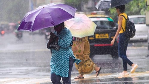 Commuters wade through Mumbai rains.