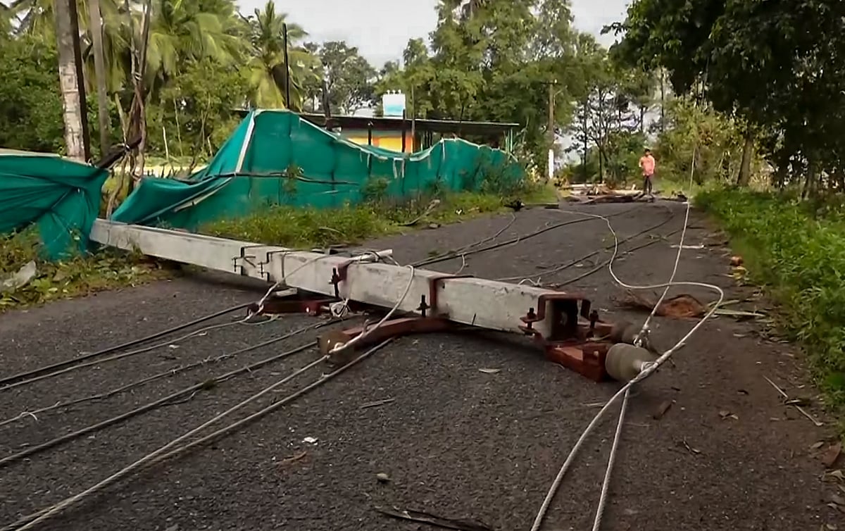 Machilipatnam: A broken electric pole lies across a road with wires scattered.