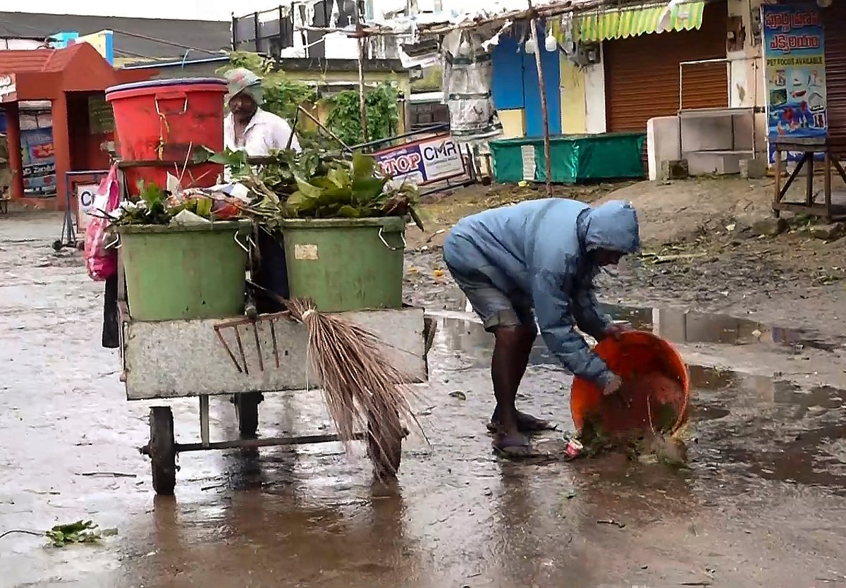 Sanitation staff clears road after landfall in Andhra Pradesh's Machilipatnam. 