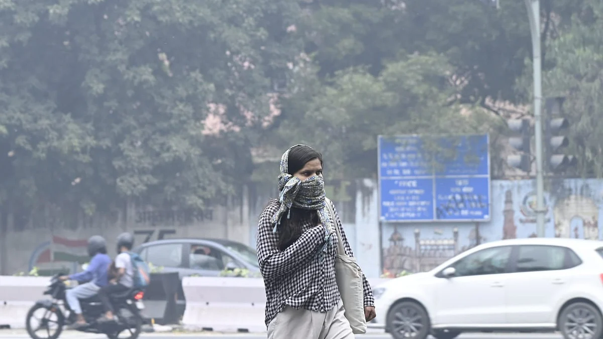 A woman shields herself from Delhi’s rising smog.