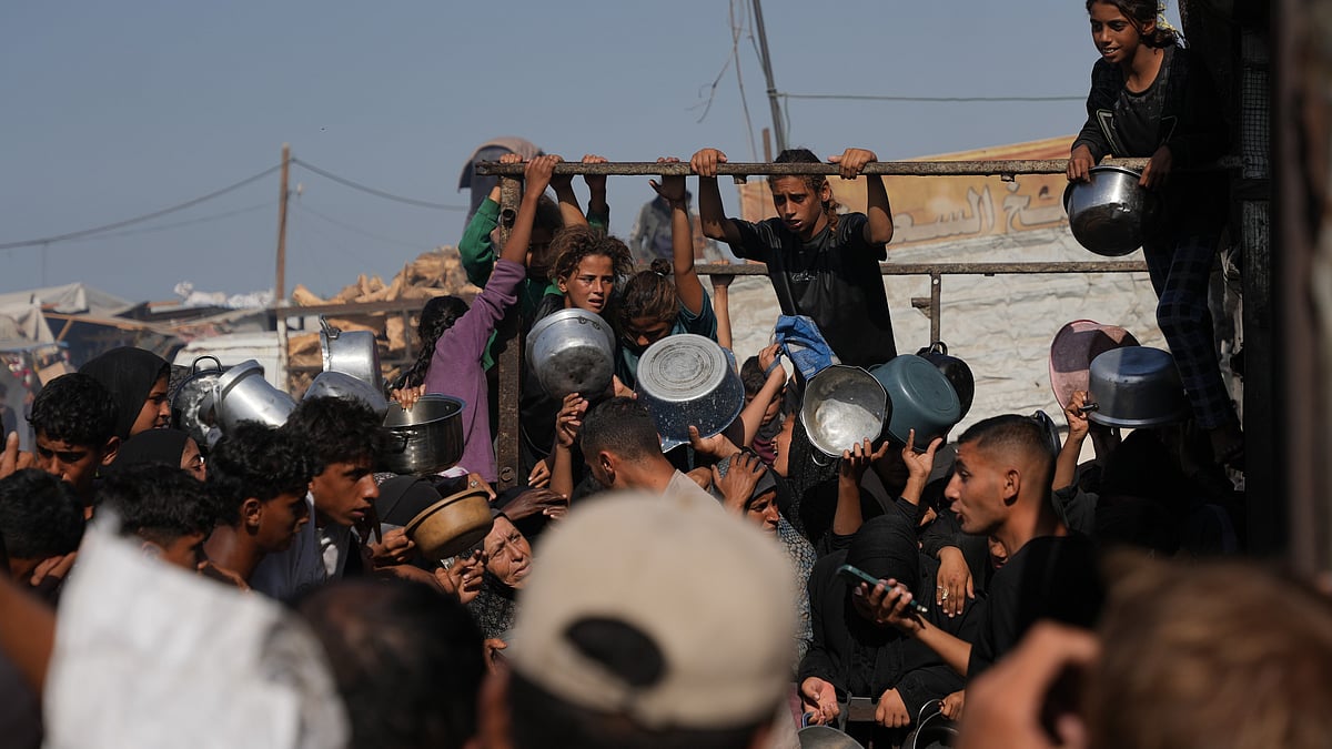 Palestinians queue for aid at a community kitchen in Khan Younis.