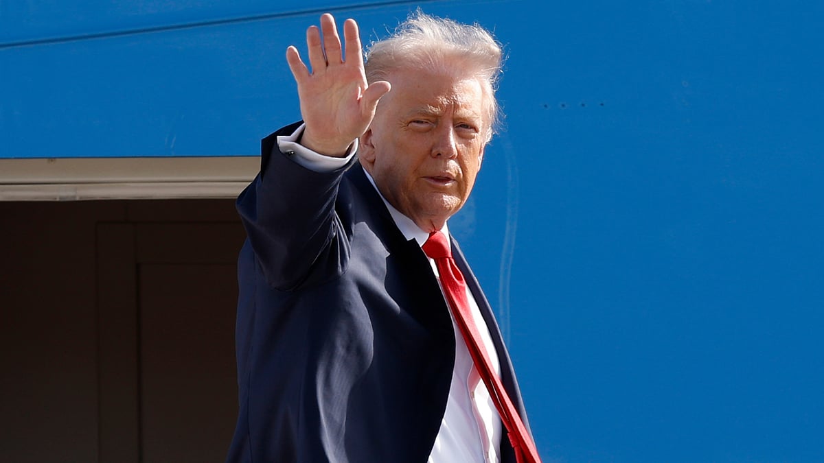 Donald Trump waves while boarding Air Force One.