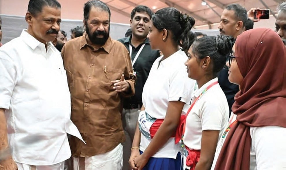 State education minister V. Sivankutty (second from left) with school children