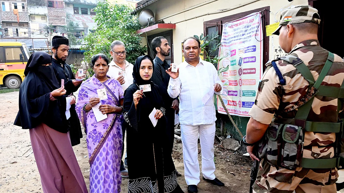 Voters show ID cards before casting ballots in the first phase of Bihar assembly polls in Patna.