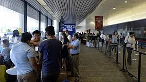 Airport officials urge patience and advise travellers to check flight statuses as delays worsen.