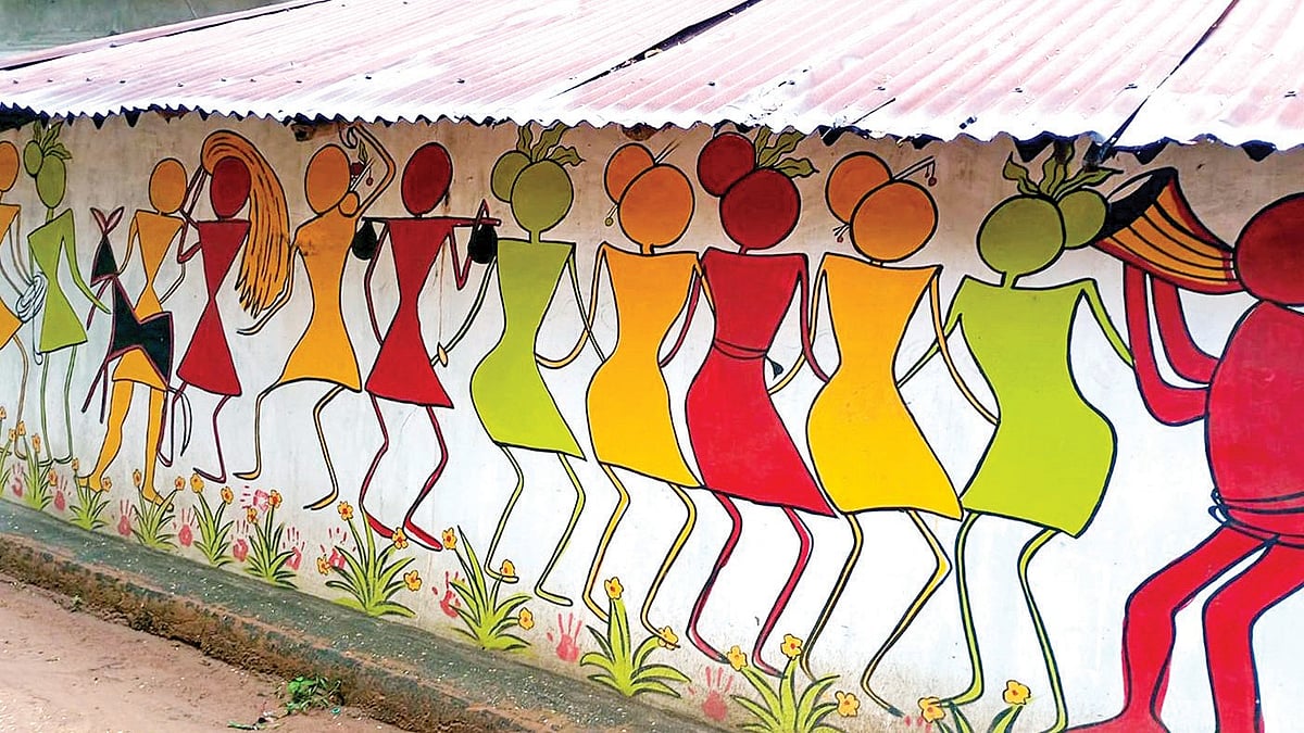 Applying a fresh coat of mud on the walls every year is mostly done by women in a Santal family