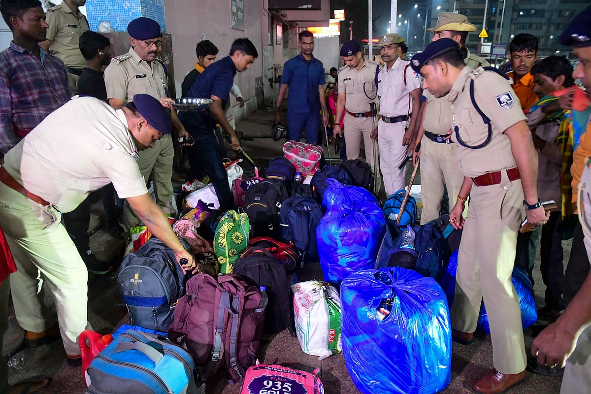 A bomb disposal squad checks luggage at a railway station in Patna district, Bihar