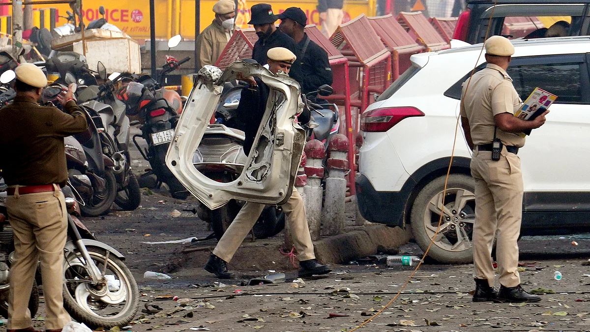 Police personnel inspect the site after the blast near Red Fort Metro Station.