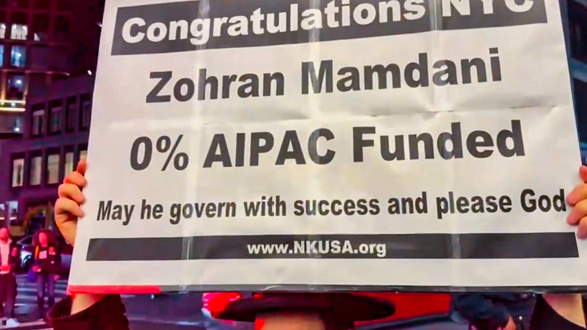 A supporter holds a poster pointing out Zohran Mamdani's lack of corporate funding  after his win