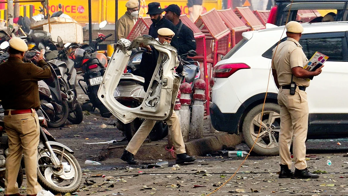Police personnel inspect the blast site