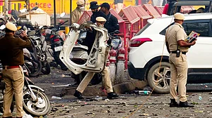 Police personnel inspect the blast site