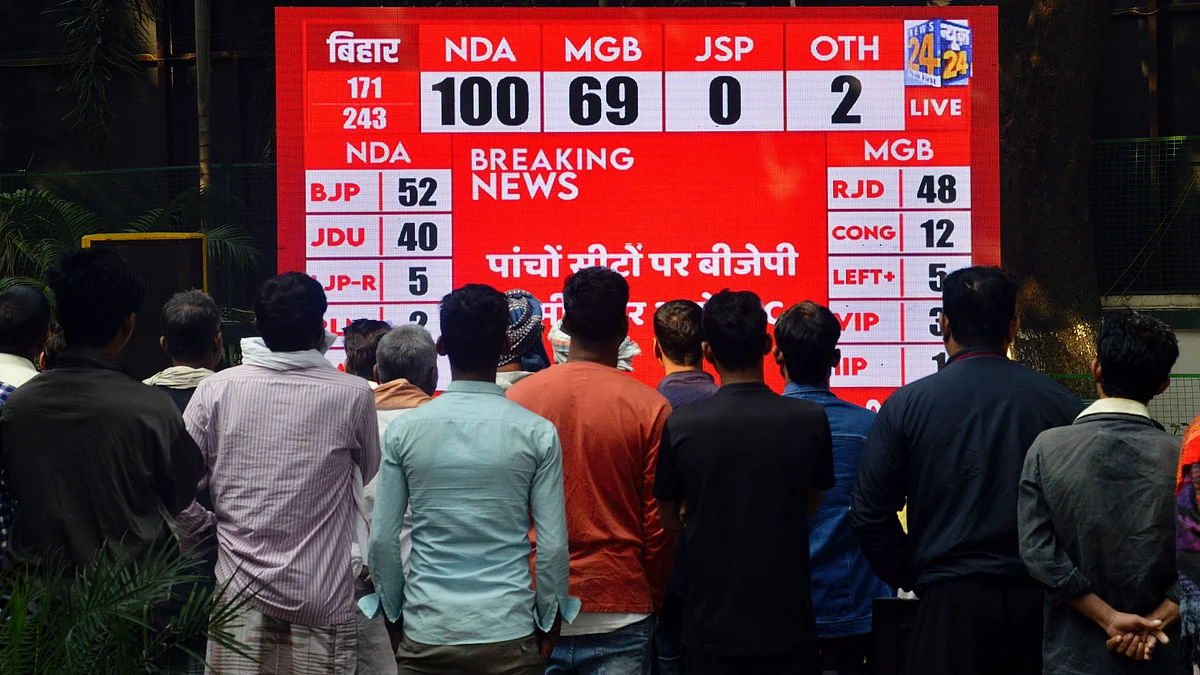 People watch a live broadcast of the results as vote counting progresses, in Patna (photo: PTI)