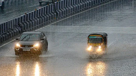 Traffic pushes on as a steady downpour drenches the city.