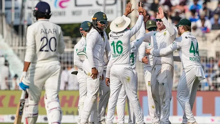 Axar Patel (left) falls in trying to give the charge to Keshav Maharaj
