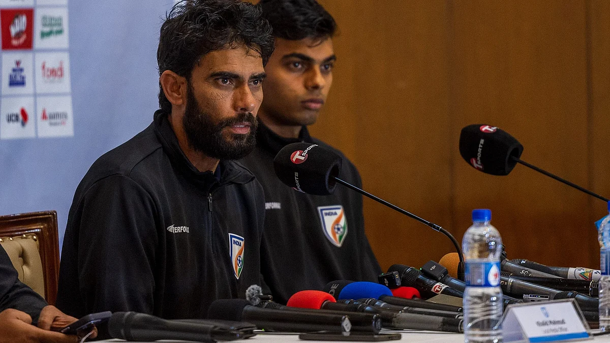 Khalid Jamil with new goalkeeper Shahil, 19, at press conference.