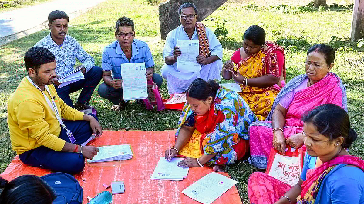A BLO oversees the filling of enumeration forms for the SIR in Malda, West Bengal