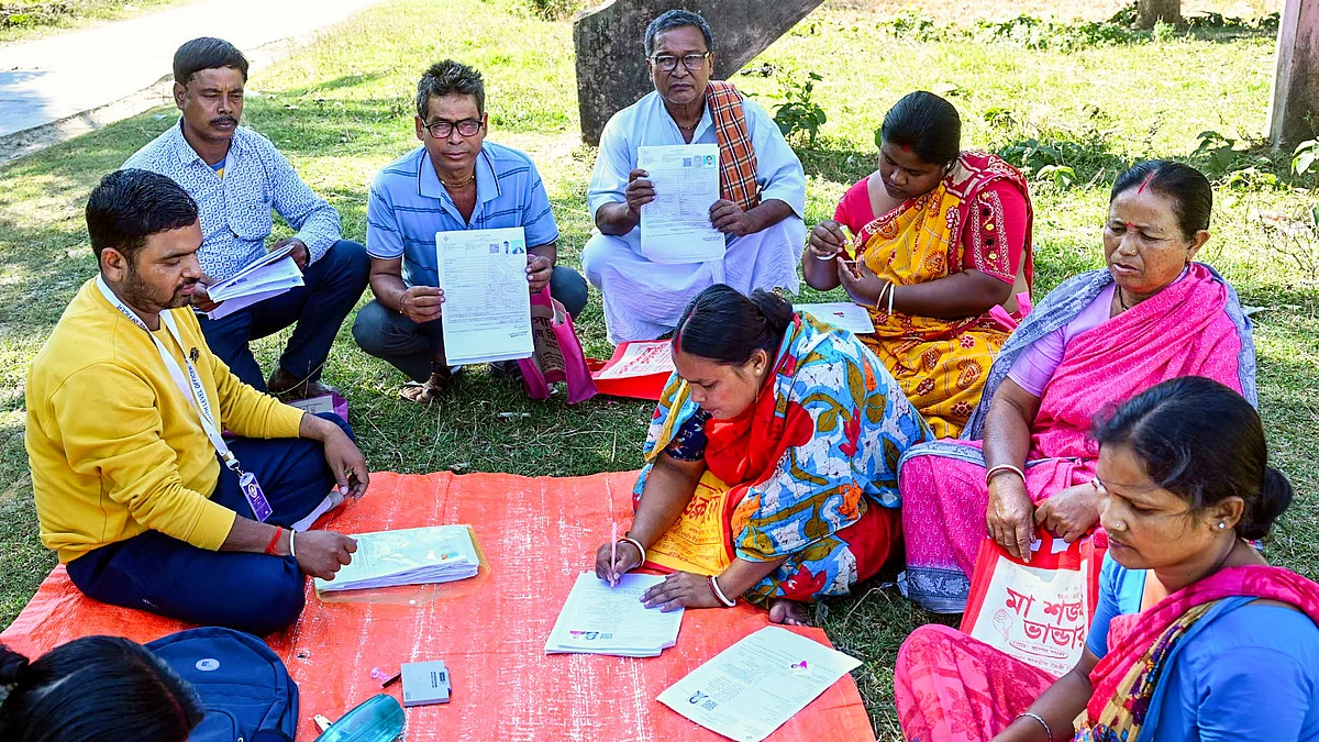 A BLO oversees the filling of enumeration forms for the SIR in Malda, West Bengal.