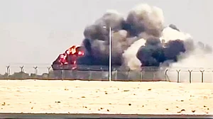 The fighter jet crashing to the ground, engulfed in a fireball