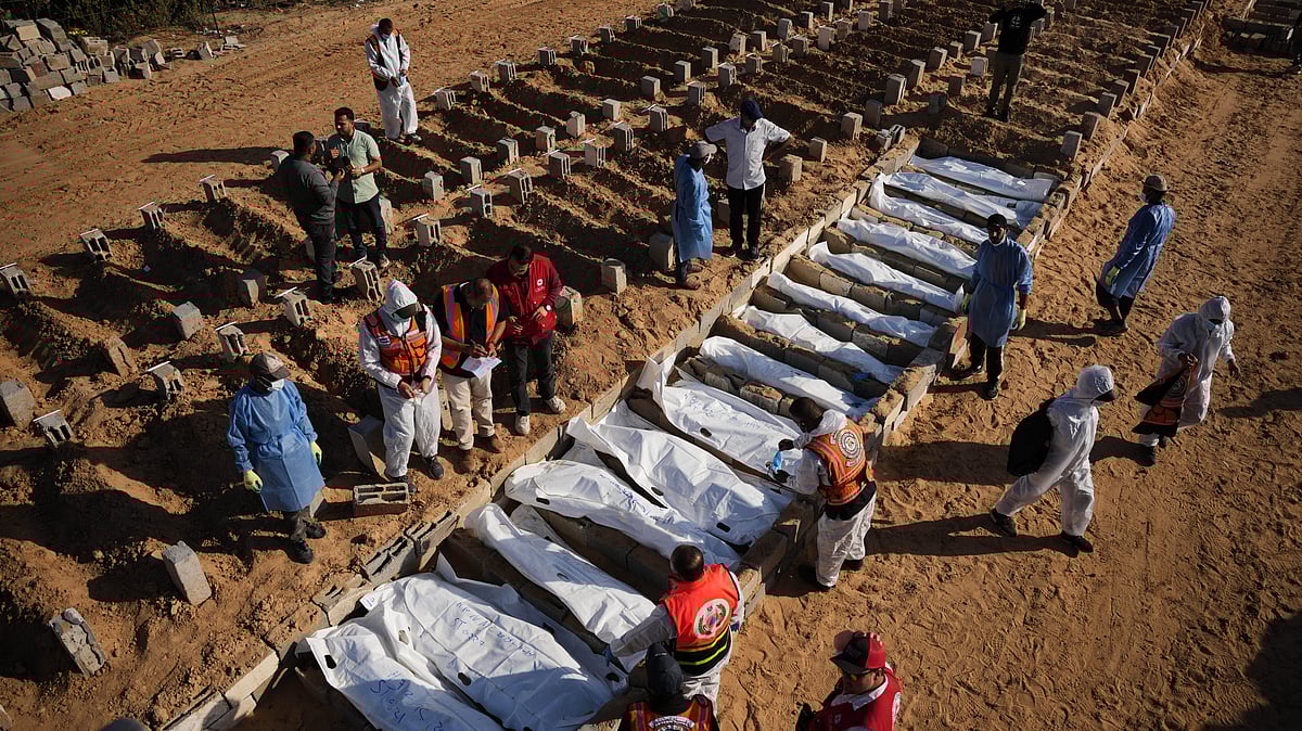 Unidentified Palestinians returned under the ceasefire deal are buried in Deir al-Balah, Gaza.