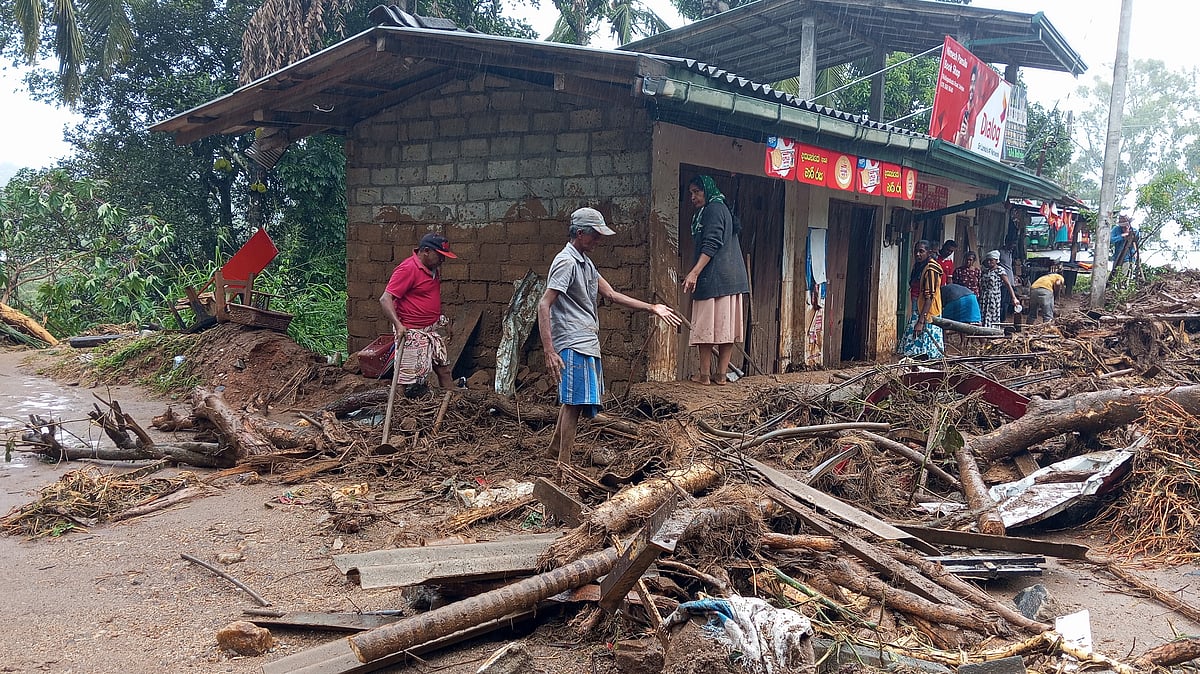 Survivors clear landslide debris in Hanguranketha, Sri Lanka.
