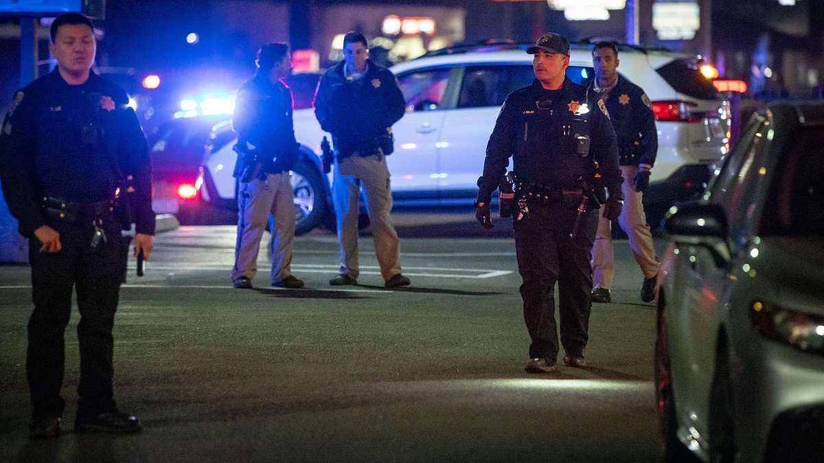 First responders move through a parking lot near the scene in Stockton.