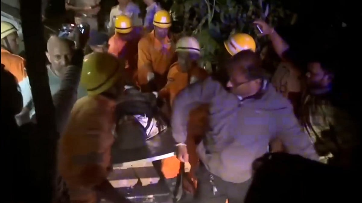 Rescue workers carry a victim out of the charred nightclub in North Goa.