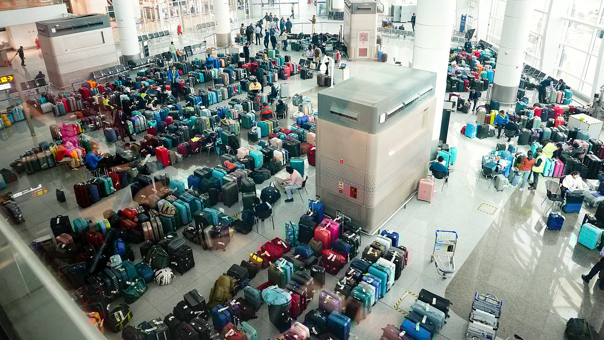 Luggage piled up at Delhi's Indira Gandhi International Airport amid IndiGo flight disruptions, 8 Dec