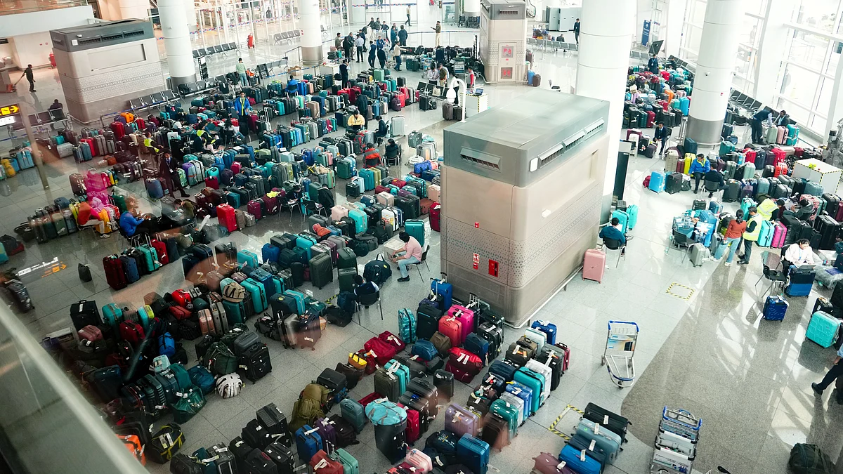 Luggage piled up at Delhi's Indira Gandhi International Airport amid IndiGo flight disruptions, 8 Dec