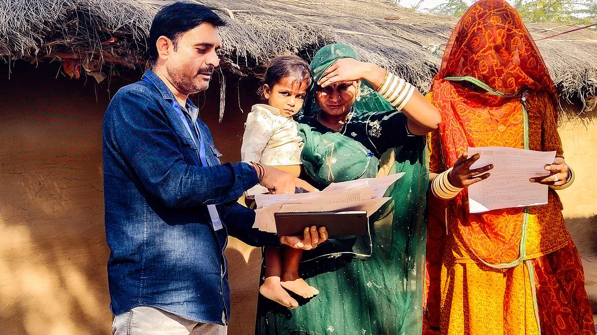 A BLO assists voters with SIR enumeration forms in Bikaner, Rajasthan