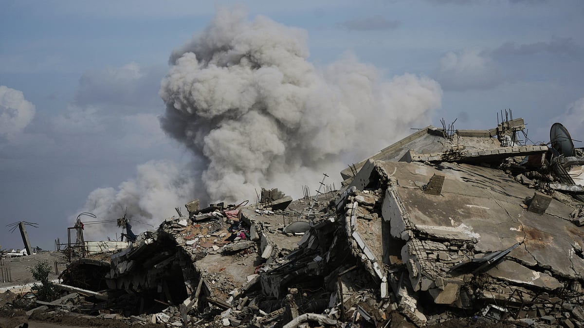 Smoke rises as Israeli military demolishes a house east of Gaza City, 9 Dec