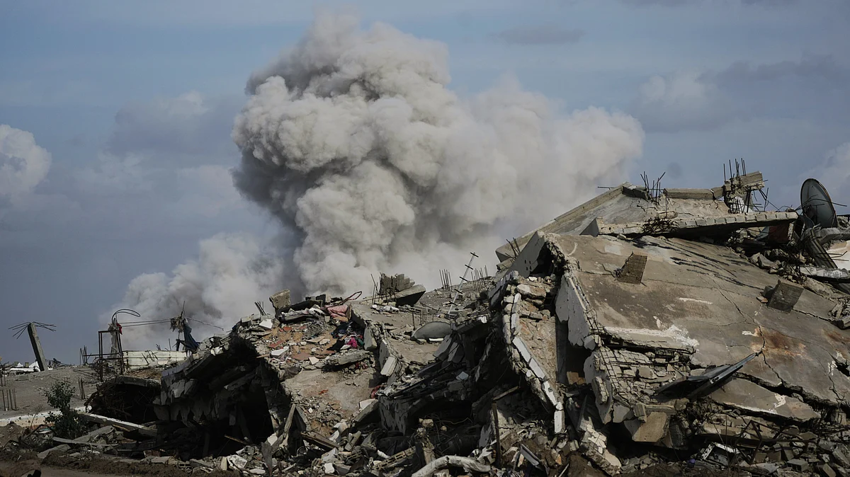 Smoke rises as Israeli military demolishes a house east of Gaza City, 9 Dec
