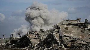 Smoke rises as Israeli military demolishes a house east of Gaza City, 9 Dec
