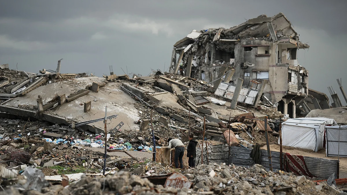 Palestinians navigate the rubble amid stormy weather in Gaza City.
